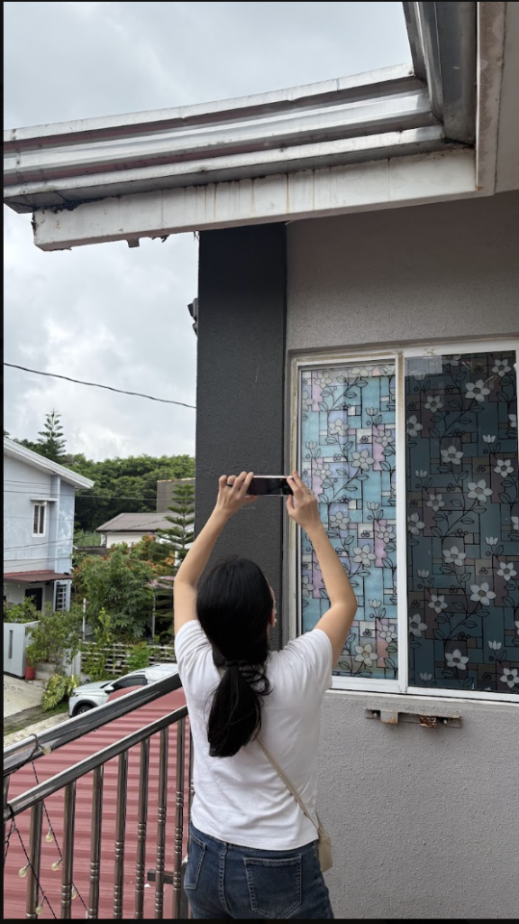 Property inspector checking house roof in Metro Manila